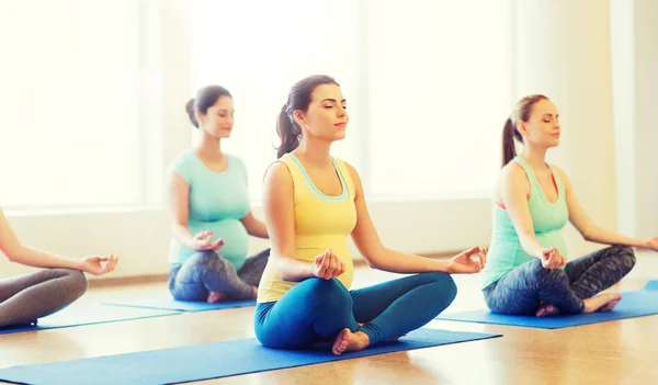 Mujeres embarazadas felices ejercitando yoga en el gimnasio — Foto de Stock