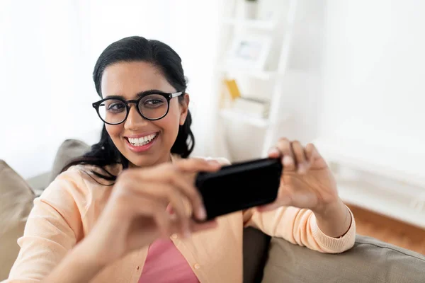 Lycklig kvinna tar selfie med smartphone hemma — Stockfoto