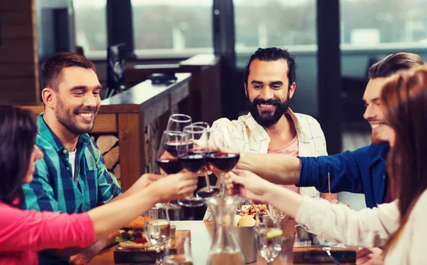 Friends dining and drinking wine at restaurant — Stock Photo, Image