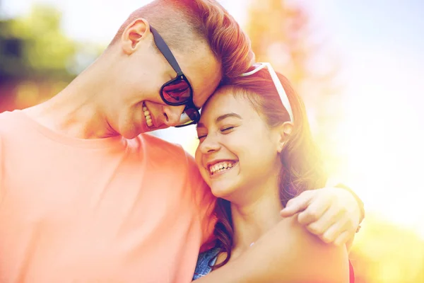 Happy teenage couple hugging at summer — Stock Photo, Image