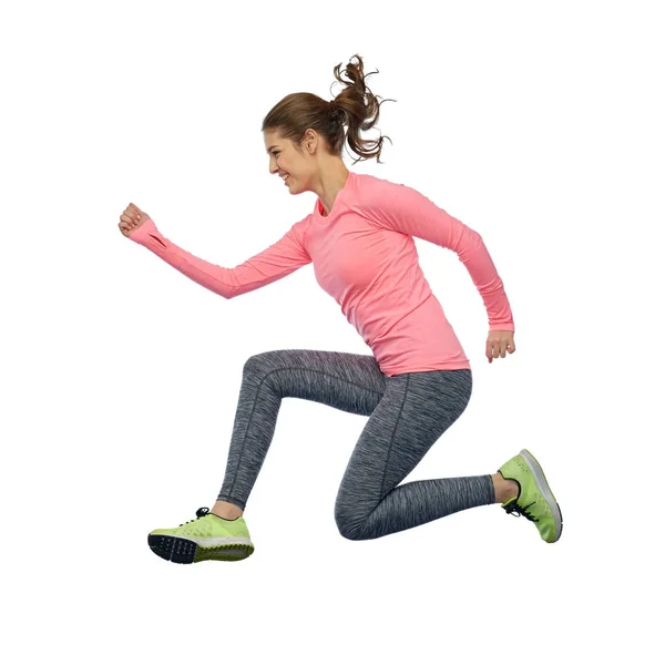 Happy smiling sporty young woman jumping in air — Stock Photo, Image