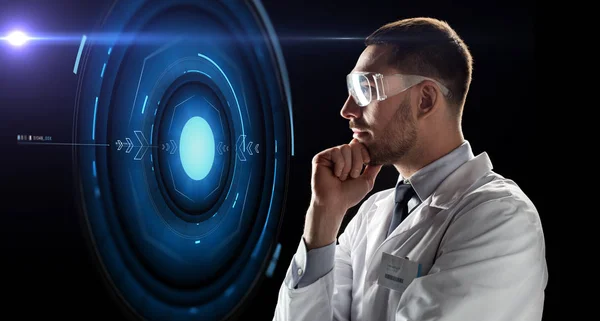 Scientist in goggles looking at virtual projection — Stock Photo, Image