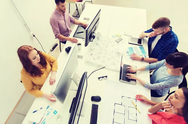 Creative team with computers, blueprint at office — Stock Photo, Image