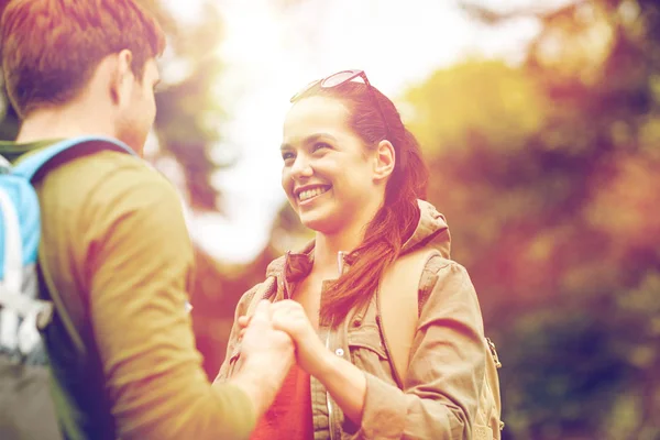 Happy couple with backpacks hiking outdoors — Stock Photo, Image