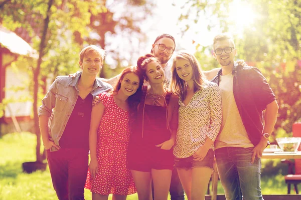 Happy teenage friends hugging at summer garden — Stock Photo, Image