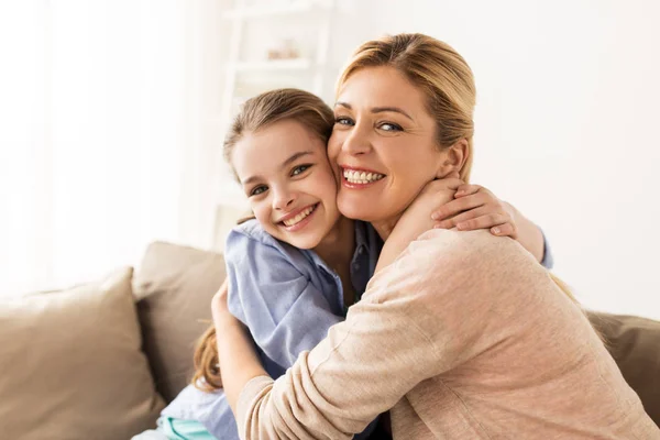 Happy smiling family hugging on sofa at home — Stock Photo, Image