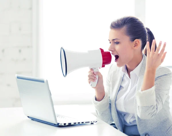 Strict businesswoman shouting in megaphone — Stock Photo, Image