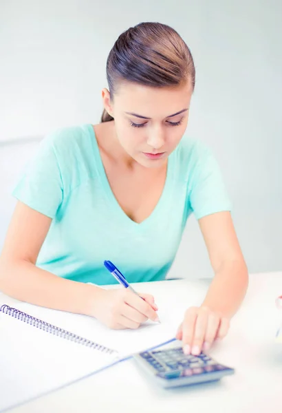 Student girl with notebook and calculator Stock Photo