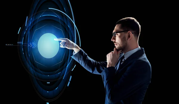 Businessman with virtual projection over black — Stock Photo, Image