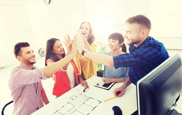 Creative team making high five at office — Stock Photo, Image