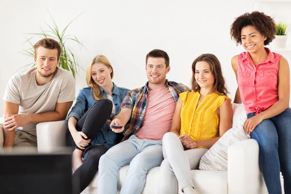 Happy friends with remote watching tv at home — Stock Photo, Image