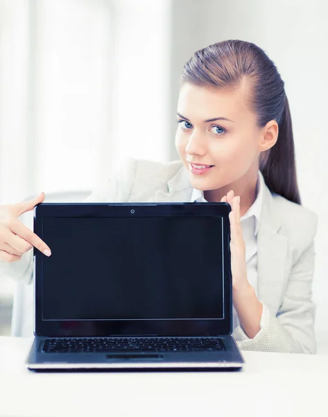 Businesswoman with laptop in office — Stock Photo, Image