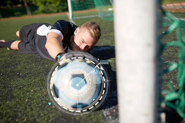 Goleiro com bola no gol de futebol em campo — Fotografia de Stock