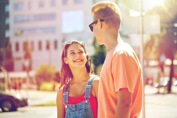 Happy teenage couple looking at each other in city — Stock Photo, Image