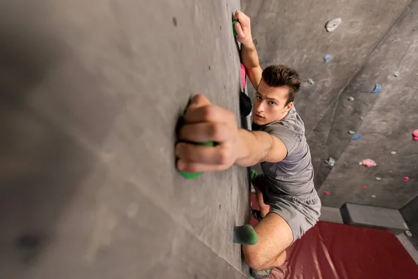 Jovem se exercitando no ginásio de escalada indoor — Fotografia de Stock