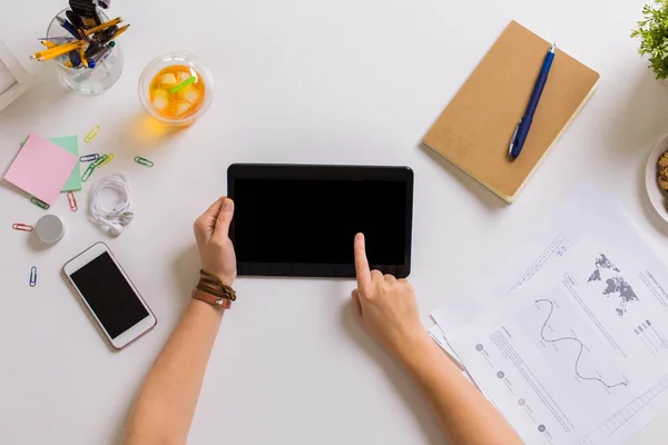 Hands with tablet pc and notebook at office table — Stock Photo, Image