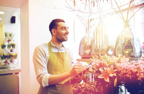 Florist man with clipboard at flower shop — Stock Photo, Image