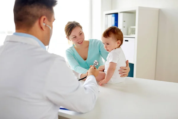 Arzt mit Stethoskop hört Baby in Klinik — Stockfoto