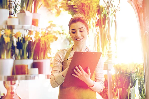 Florist woman with clipboard at flower shop — Stock Photo, Image