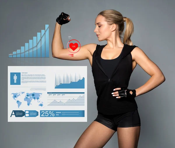 Mujer joven mostrando músculos con gráficos y pulso — Foto de Stock
