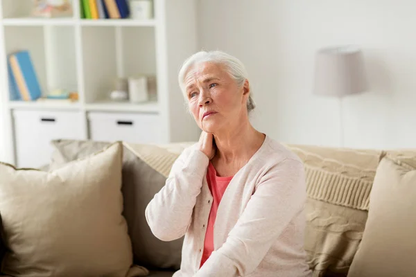 Donna anziana che soffre di dolore al collo a casa — Foto Stock