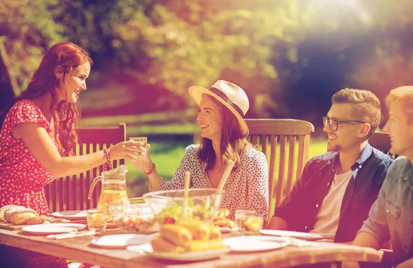 Glückliche Freunde beim Abendessen bei sommerlicher Gartenparty — Stockfoto