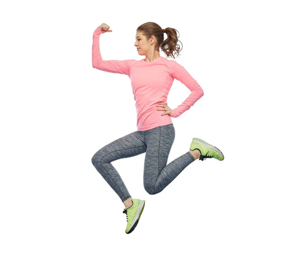 Happy smiling sporty young woman jumping in air — Stock Photo, Image