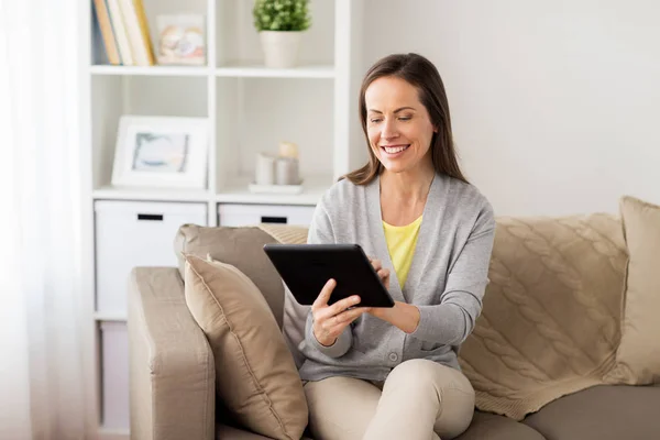 Glückliche Frau mit Tablet-PC zu Hause — Stockfoto