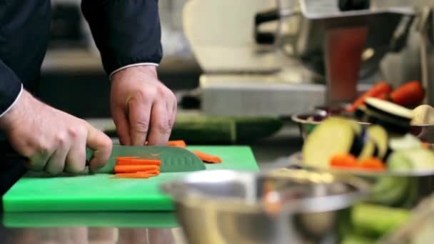 Manos de chef masculino cocinero picando zanahoria en la cocina — Vídeos de Stock