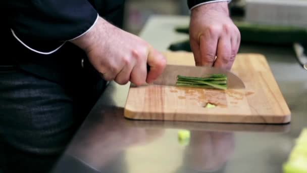 Hands of male cook chopping cucumber in kitchen — Stock Video