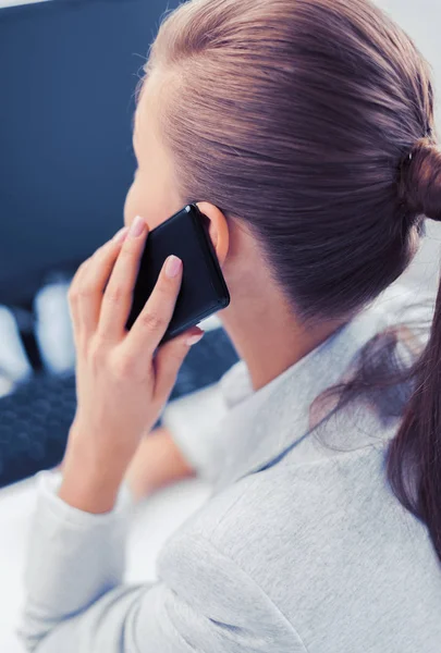 Businesswoman with smartphone in office — Stock Photo, Image