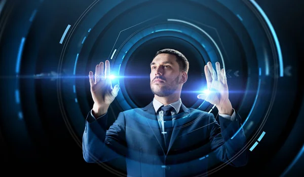 Businessman with virtual projection over black — Stock Photo, Image