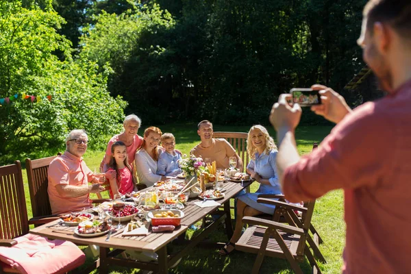 Happy family photographing by smartphone in summer — Stock Photo, Image