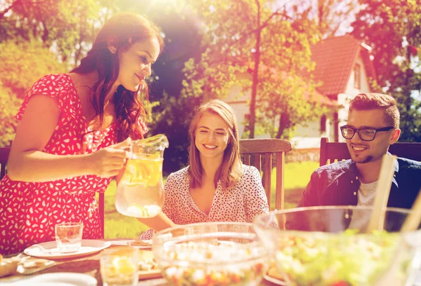 Happy vrienden hebben van diner bij zomer tuinfeest — Stockfoto