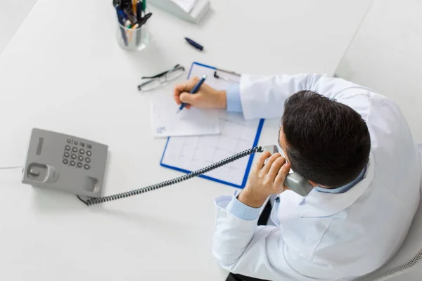 Doctor with prescription calling on phone — Stock Photo, Image