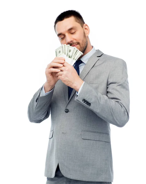 Empresário cheirando dinheiro dólar americano — Fotografia de Stock