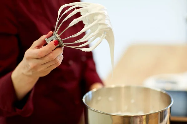 Chef with whisk and whipped egg whites at kitchen — Stock Photo, Image