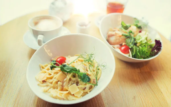 Close up of pasta in bowl on table at restaurant — Stock Photo, Image