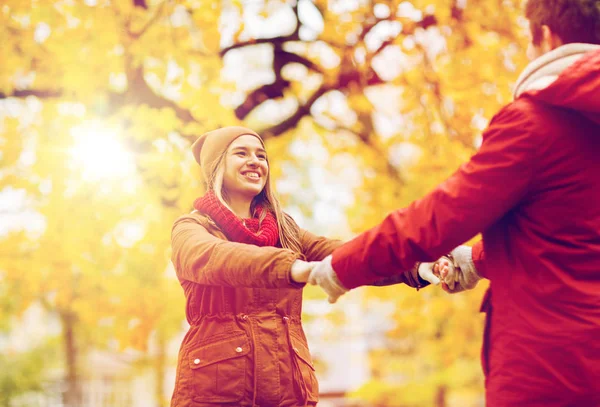 Feliz jovem casal se divertindo no parque de outono — Fotografia de Stock