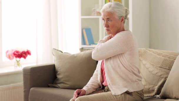 Mujer mayor que sufre de dolor de cuello en casa — Vídeo de stock