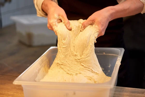 Chef or baker cooking dough at bakery — Stock Photo, Image