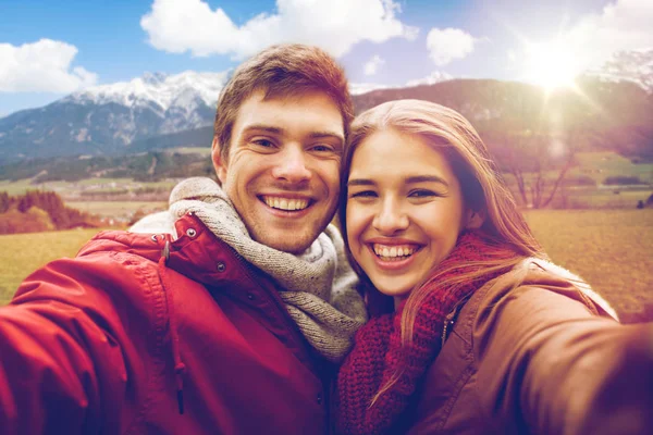 Happy couple taking selfie over alps mountains — Stock Photo, Image