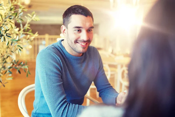 Happy couple talking at cafe or restaurant — Stock Photo, Image