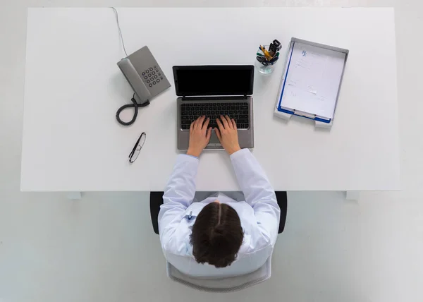 Doctor tastând pe laptop la clinică — Fotografie, imagine de stoc