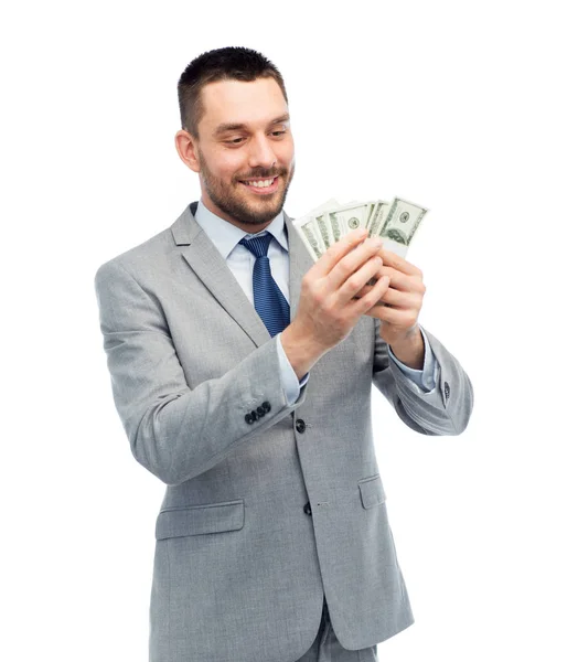 Homem de negócios sorrindo contando dinheiro dólar americano — Fotografia de Stock