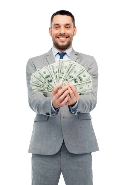 Uomo d'affari sorridente con soldi del dollaro americano — Foto Stock