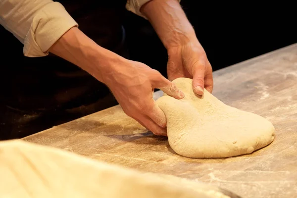 Chef or baker cooking dough at bakery — Stock Photo, Image