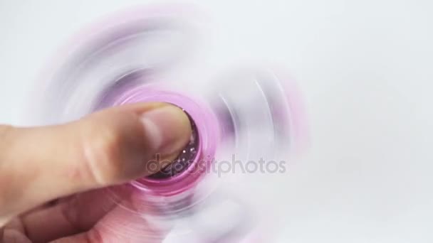 Hand playing with spinning fidget spinner — Stock Video