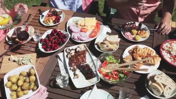 Happy family having dinner or summer garden party — Stock Video