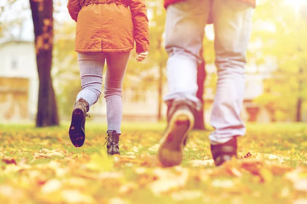 Young couple running in autumn park — Stock Photo, Image